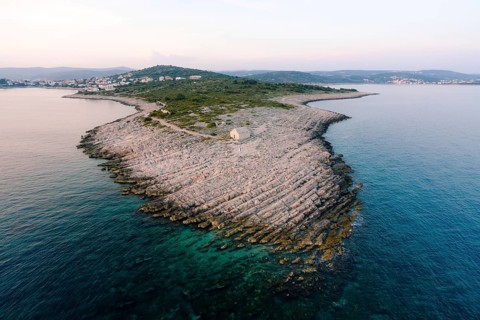 Cape Punta Planca with an old stone church. Aerial view.