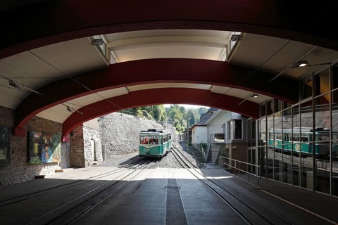 Valley station with arriving railcar