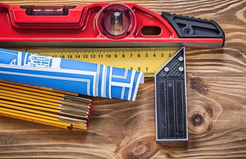 Construction level blue blueprint wooden meter square ruler on vintage wood board