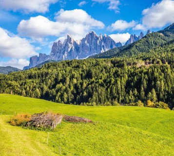 Warm autumn in the Dolomites, the Val de Funes. The valley is surrounded by a dentate wall of