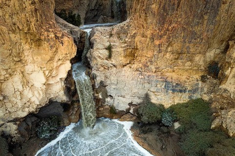 Powerful waterfall in the Judean Desert around the Dead Sea after heavy winter rains. Israel.