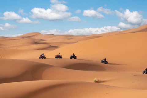 Motorbikers driving off-road in the Erg Chebbi desert near Merzouga, Morocco, Africa