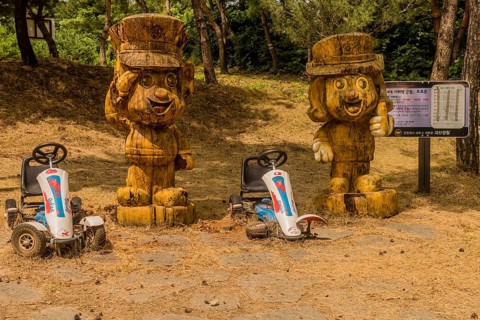 Geosan, South Korea, August 26, 2020: Carved wood statues of Korean police officers in mountain