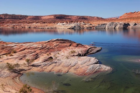 Antelope Canyon in the Navajo Reservation. Two boats with oars float near the water channel