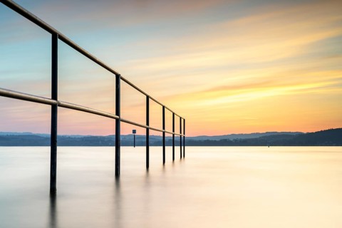 Railing in the lake in the warm light of the sunset, quiet atmosphere, lido, Litzelstetten, Lake