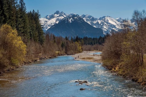 The spring-like Iller with the Oberstdorf Alps in the background in Fischen, Allgäu, Swabia,