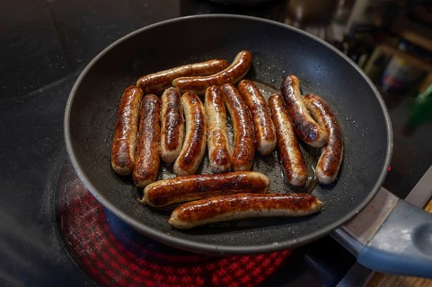 Nuremberg sausages in the pan on the cooker, Bavaria, Germany, Europe