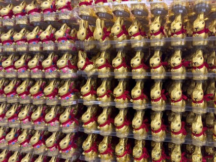 Display on shelf of retail wholesale of large number of chocolate Easter bunnies chocolate Easter