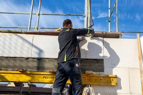 Bricklayer works on a new detached house