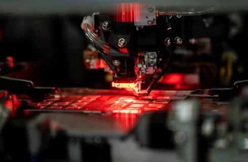 Robotic machine manufacturing semiconductor computer ship at a stall to show investors, during The