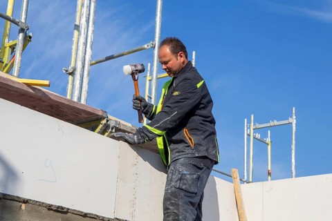 Bricklayer works on a new detached house