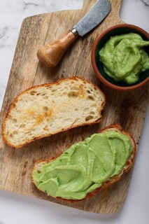 Ciabatta with avocado pasta, breakfast, on a chopping board, top view, homemade, no people
