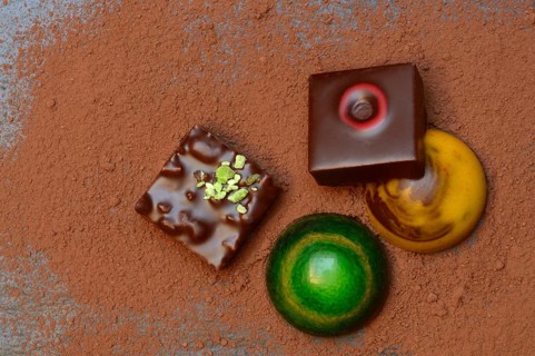 Colourful chocolates on cocoa powder