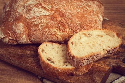 Sliced ciabatta, on a chopping board, italian bread, close-up, Italian cuisine, breakfast, no