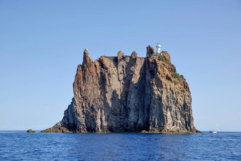 Rock island Strombolicchio with lighthouse, near island Stromboli, Lipari Islands, Tyrrhenian Sea,