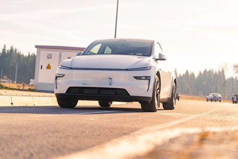 Modern white car on an asphalt road with natural landscape in the background, Tesla, New Model Y