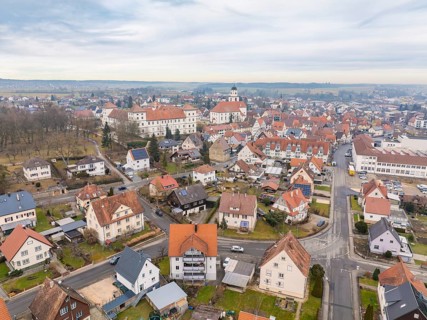 Overview of a charming town with a dominant church tower in the middle of a quiet neighbourhood,