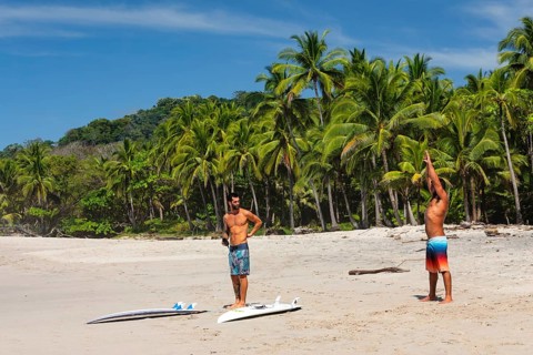 Surfers warming up on the beach of Santa Teresa, Nicoya Peninsula, Guanacaste, Costa Rica, Central