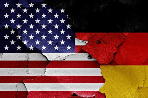 Flags of United States and Germany painted on cracked wall