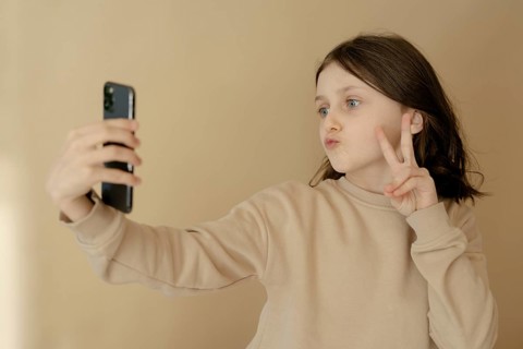 Girl, 10, takes a selfie with mobile phone