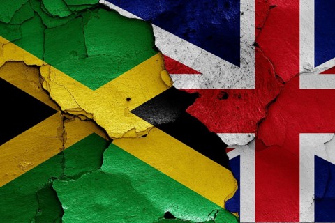Flags of Jamaica and UK painted on cracked wall