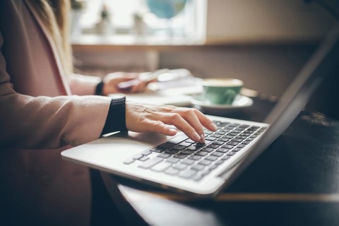 Close-up top view of Caucasian woman's hands Casually dressed student, blogger, writer man working