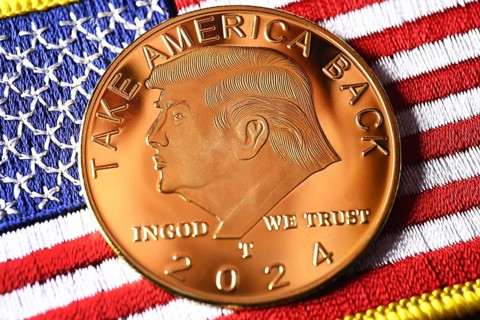 Election campaign coin with portrait of Donald Trump on USA flag, symbolic photo US presidential
