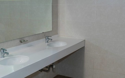 Closeup of double sink and mirror in public restroom in South Korea