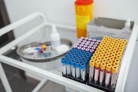 Blood test tubes on the glass table in clinic. Close up