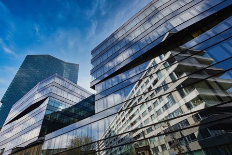 Modern glass building with impressive reflection of the blue sky in the city, Prime Tower, Zurich,