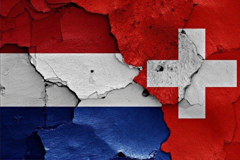 Flags of Netherlands and Switzerland painted on cracked wall