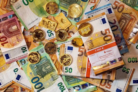 Gold and banknotes, euros and gold coins and gold bars, piles and bundles