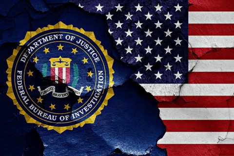 Flag of FBI and USA painted on cracked wall
