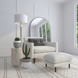 Bright living room with an armchair, plants, lamp, and large mirror
