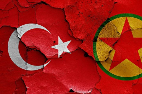 Flags of Turkey and PKK painted on cracked wall