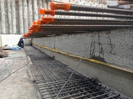 Close-up of reinforcement bars and concrete at a construction site