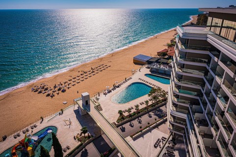View of a hotel complex with pool on the beach, the Black Sea stretches into the distance, Golden