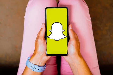 In this photo illustration, the Snapchat logo is displayed on a smartphone screen