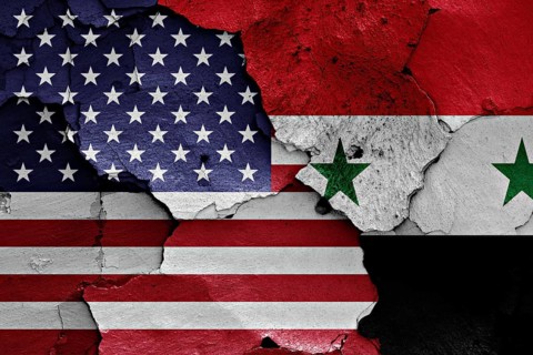 Flags of USA and Syria painted on cracked wall