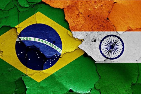 Flags of Brazil and India painted on cracked wall