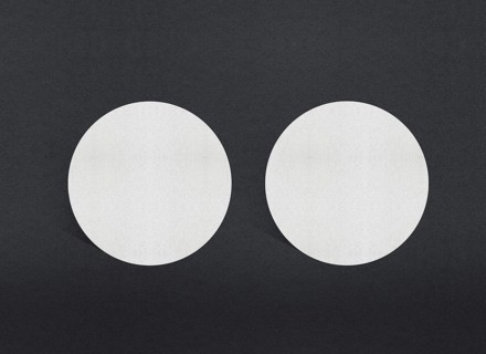 Two white circular papers symmetrically placed on a dark background, Blank white Business card