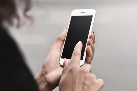 Cropped image of woman's hands holding smart phone with blank copy space screen for your text