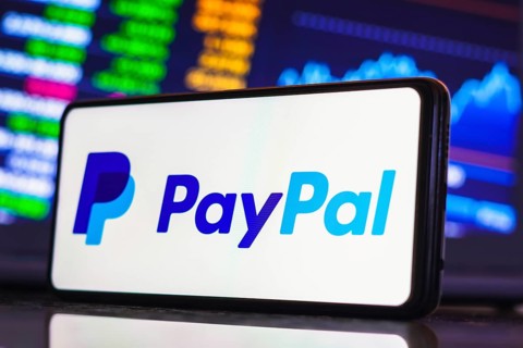 In this photo illustration, the PayPal logo is displayed on a smartphone screen