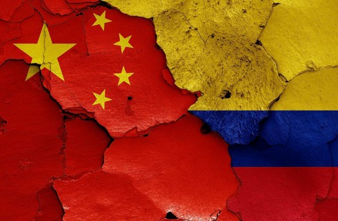 Flags of China and Colombia painted on cracked wall
