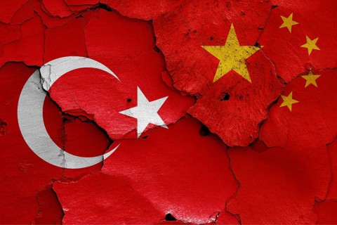 Flags of Turkey and China painted on cracked wall