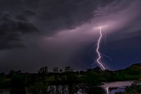 Illuminating lightning strikes the night sky over a landscape, Bogen, Lower Bavaria