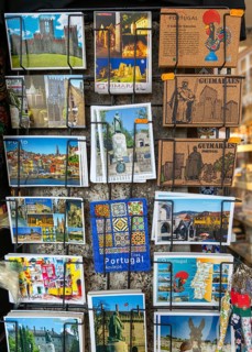 Display rack of colour picture postcards outside shop, city of Guimaraes, northern Portugal