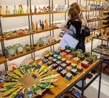 Shopping inside tourist souvenir craft shop selling pottery and ceramics, Guimaraes, northern