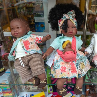 Black skinned baby dolls on display in shop window, city of Guimaraes, northern Portugal