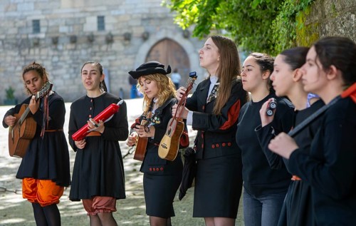 Group female university students musicians perform in street, city of Guimaraes, northern Portugal